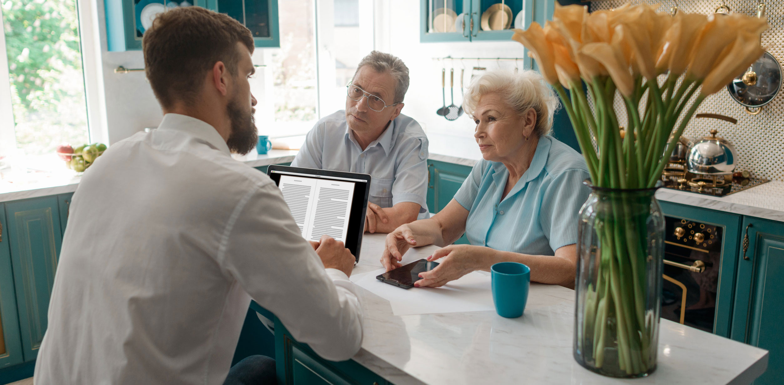Older Couple Hearing Out Property Investment Professional in Kitchen